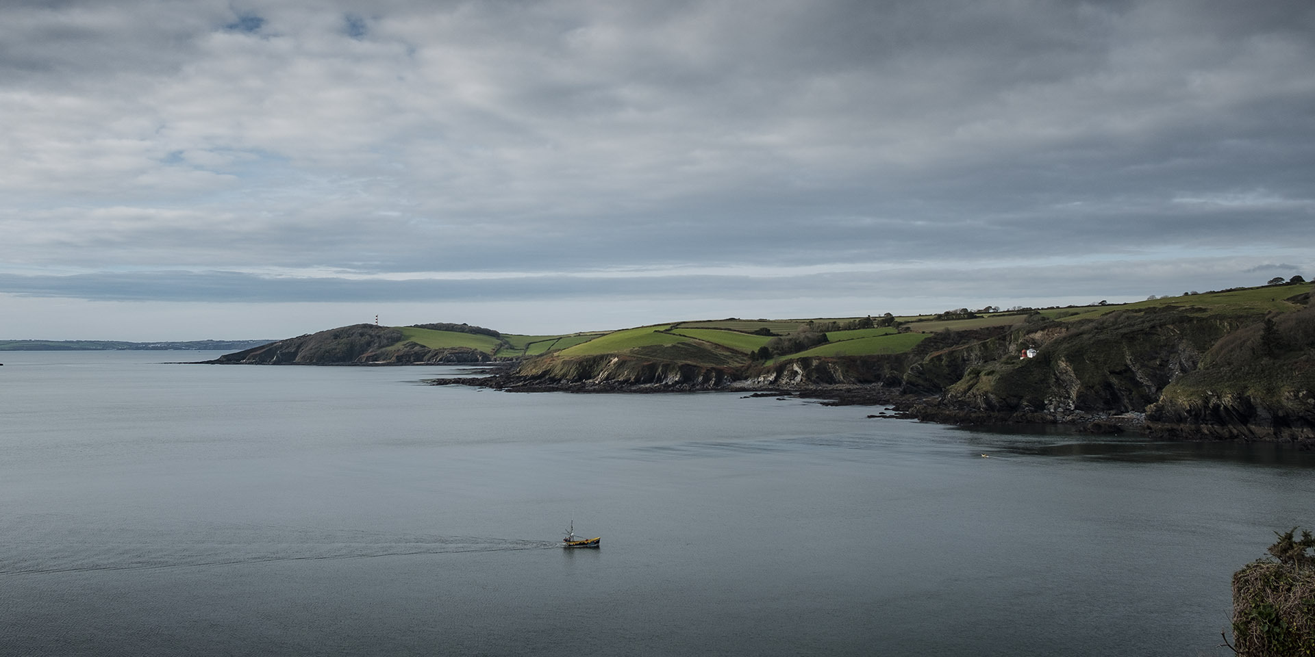 Fisherman returning to Fowey harbour, cornwall, uk inshore fishing